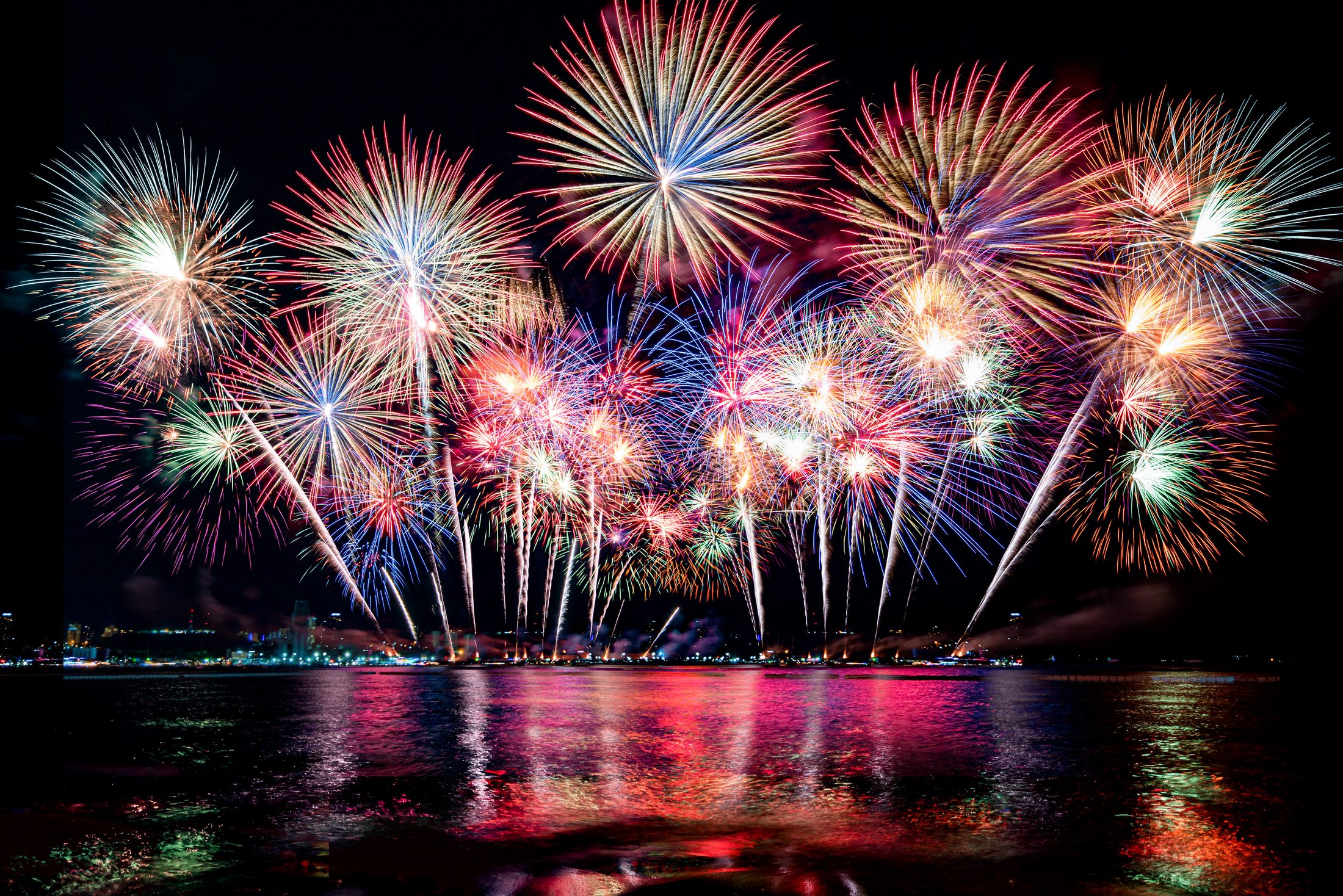 Professional firework display reflected over water