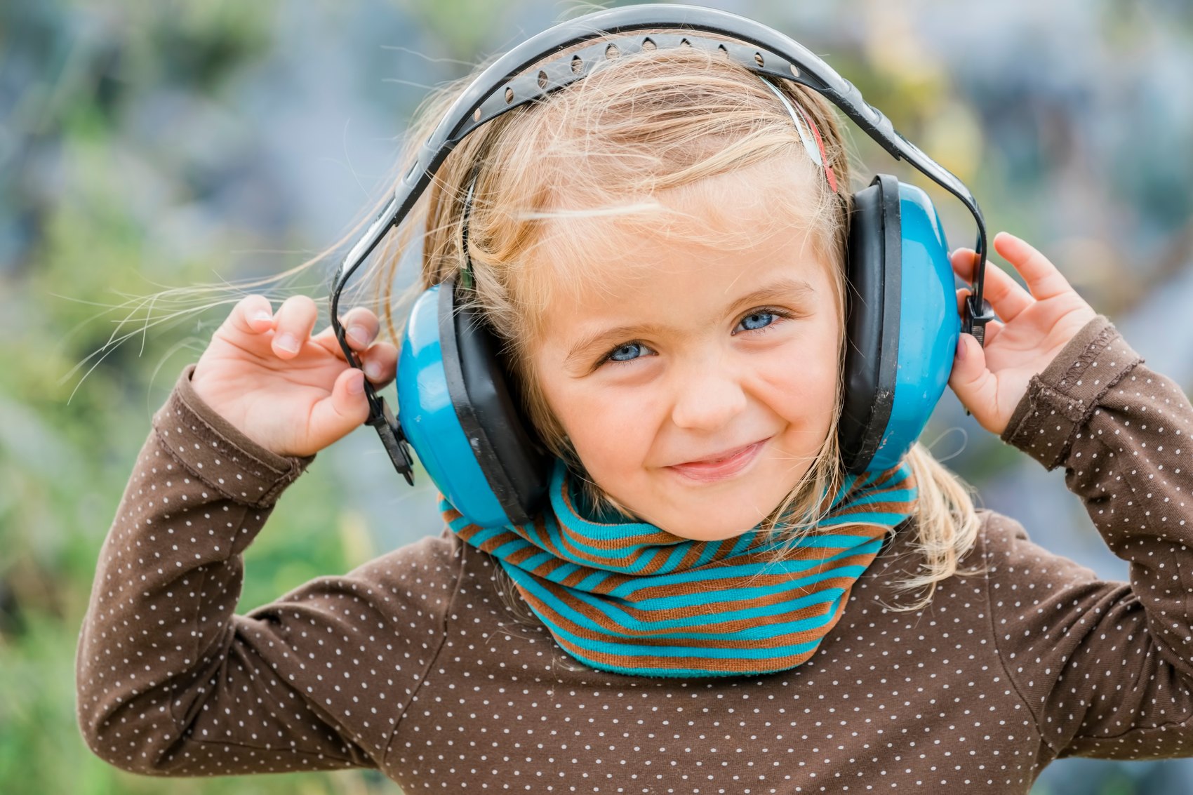 Child wearing ear defenders for a noise-sensitive event