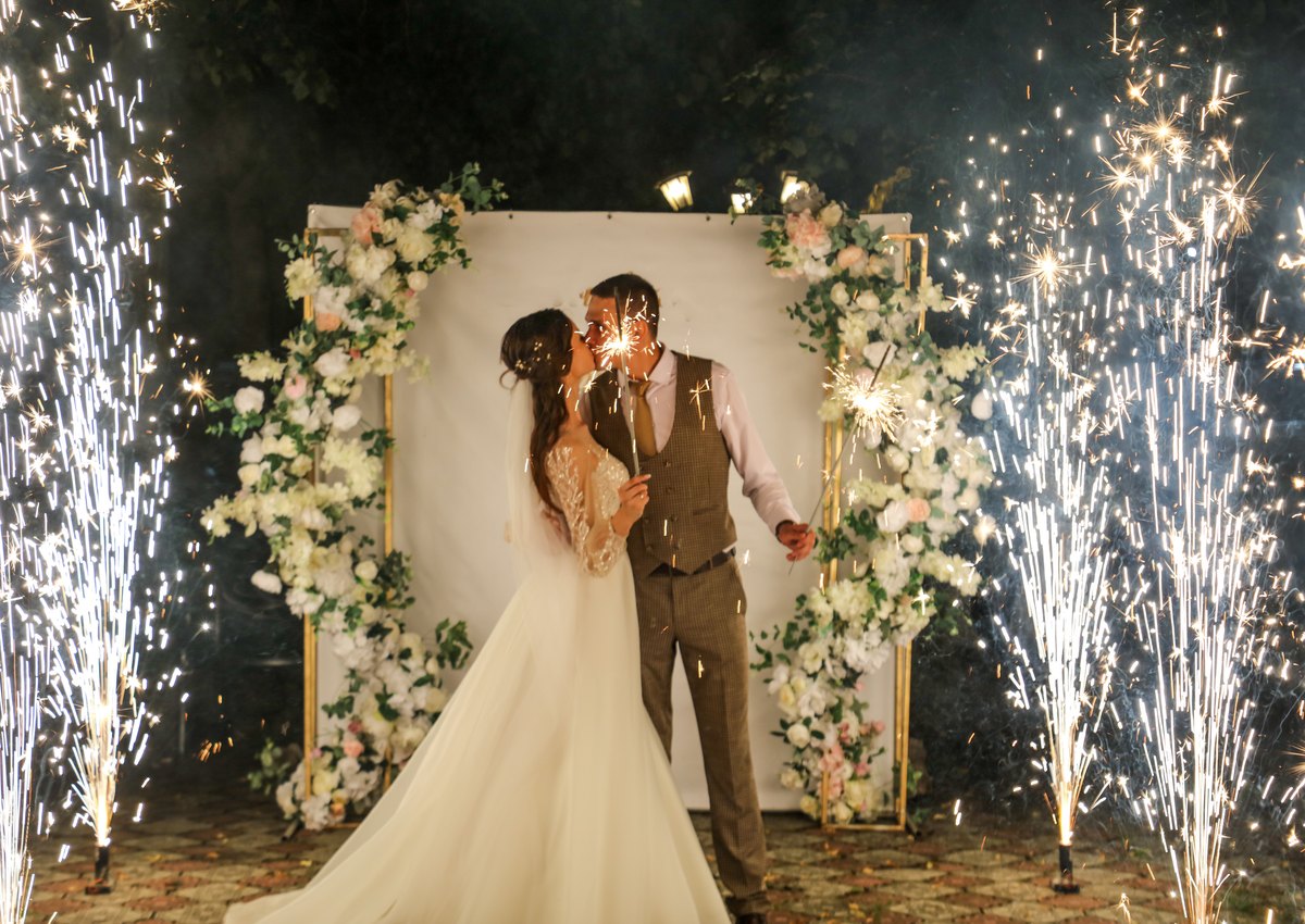 Wedding couple framed by professional spark effects